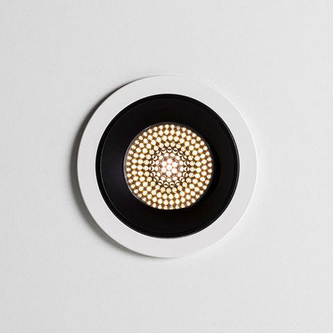 Artemide Everything recessed ceiling spotlight with white trim, black inner ring, and warm LED array in circular honeycomb pattern