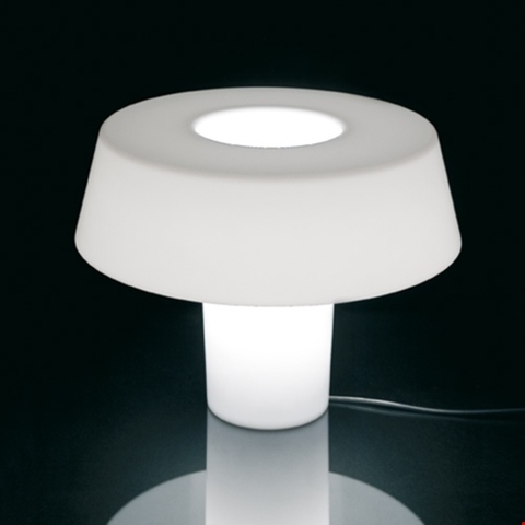 Artemide Amami table lamp: white mushroom-shaped diffuser with open top aperture, glowing cylindrical base, soft ambient light
