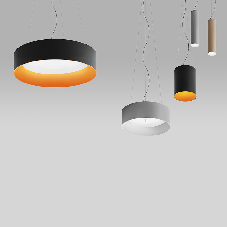 Artemide Tagora pendant lamps: large black ring with orange interior, medium grey drum, and two small cylindrical pendants in black and beige