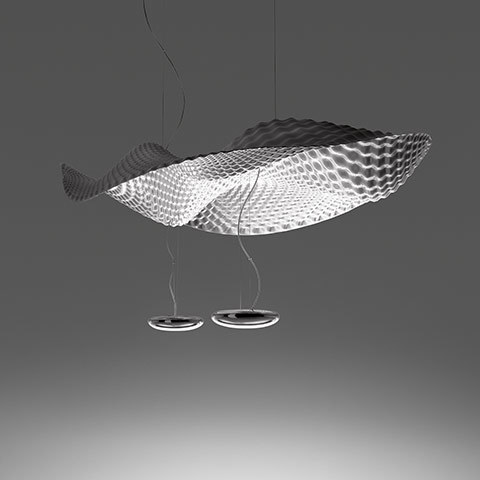 Artemide Cosmic Angel suspension lamp with large silver wave-textured shade resembling a fish, two circular LED downlights hanging below