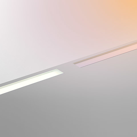 Artemide LineaLed Drive-over: two recessed ceiling linear LED fixtures flush-mounted, one illuminated emitting warm white light