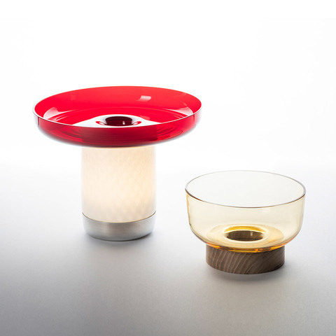 Artemide Bontà table lamps: left red dish-shaped top on glowing white cylinder base, right amber glass bowl on wooden base