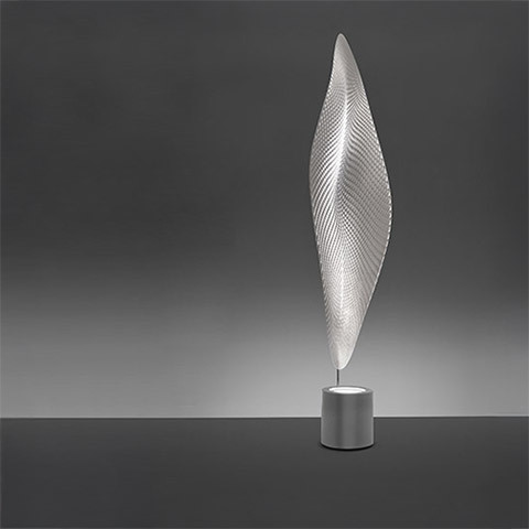 Artemide Cosmic Leaf floor lamp with a tall leaf-shaped translucent diffuser featuring a textured pattern, mounted on a cylindrical metal base