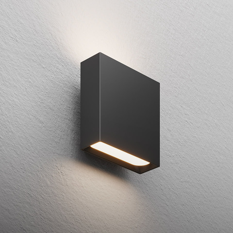 Artemide Agathe dark grey rectangular wall light with horizontal LED strip emitting warm light upward and downward