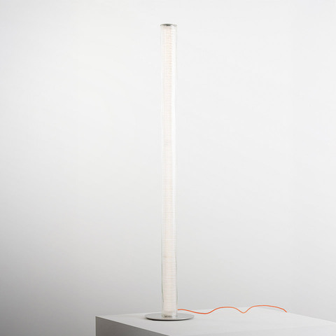 Artemide Criosfera floor lamp: tall slender white cylindrical diffuser on a round base with a distinctive orange power cord
