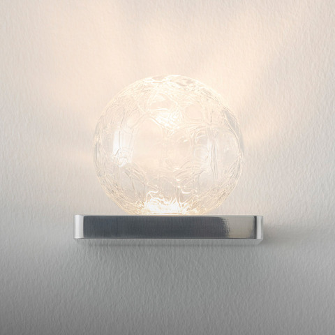 Artemide Ulrich und Diotima wall lamp: textured clear glass sphere on a polished chrome rectangular base, emitting warm diffused light