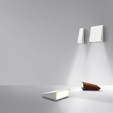Artemide Cuneo collection: two white wall lights projecting downward beams, plus white and wood-finish wedge-shaped floor lamps