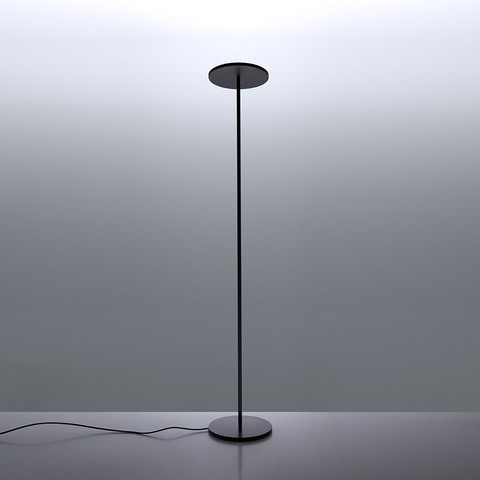 Artemide Athena INTEGRALIS floor lamp in black, featuring a slender stem, circular disc diffuser on top, and flat round base