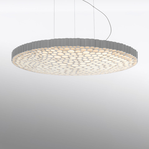 Calipso pendant lamp by Artemide: large circular disc with honeycomb LED diffuser pattern, grey ribbed edge, suspended by thin cables