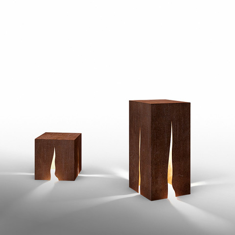 Artemide Granito floor lamps: two Corten steel rectangular blocks in small and large sizes, emitting warm light through vertical cracks