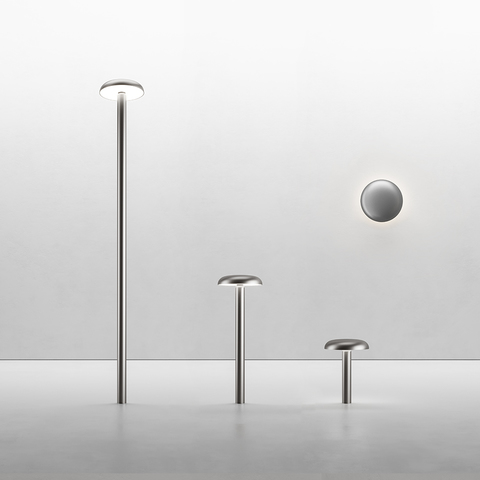 Artemide Knop collection: three outdoor bollard lights in graduated heights and a wall light, all in brushed aluminum with disc-shaped heads