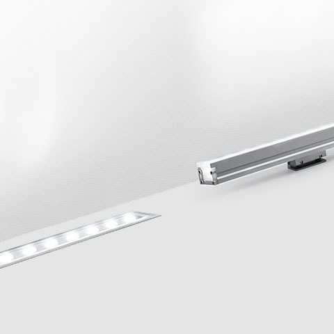 Artemide LineaLed wallwasher: recessed linear LED fixture in white surface beside its aluminum profile component