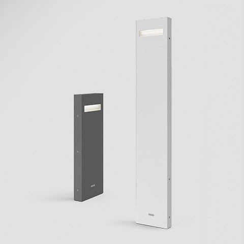 Artemide Nuda outdoor bollard lights: short dark grey unit and tall white unit, each with a rectangular LED aperture near the top