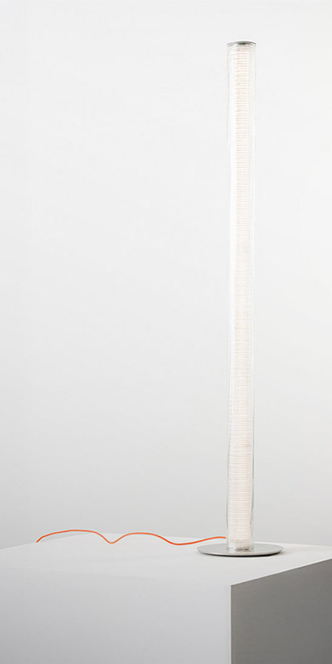 Artemide Criosfera floor lamp: tall slender white cylindrical diffuser on a round base with a distinctive orange power cord