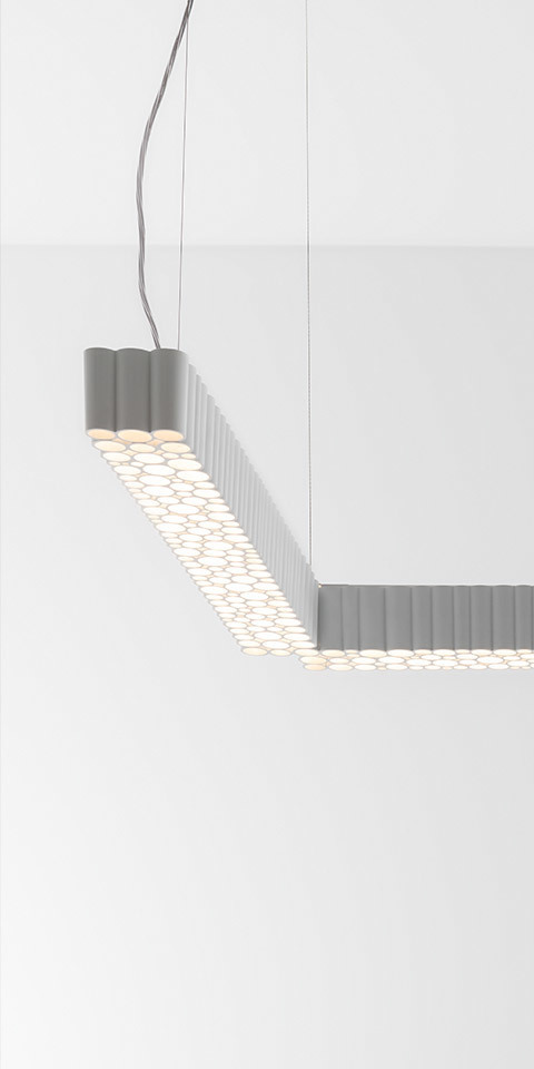 Calipso Architectural Indoor pendant lamp by Artemide: angular gray aluminum profile with honeycomb LED diffuser, suspended by cables