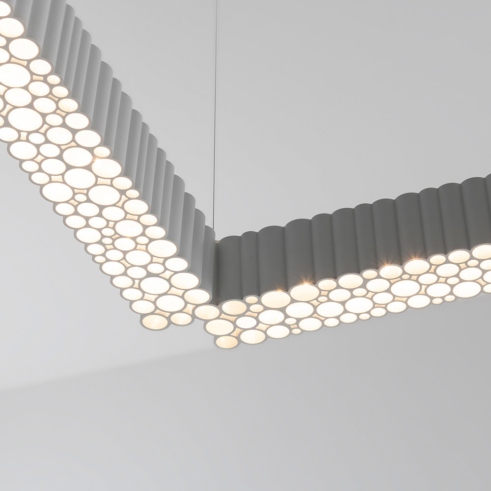 Calipso linear suspension system with fractal geometry diffuser and warm light.