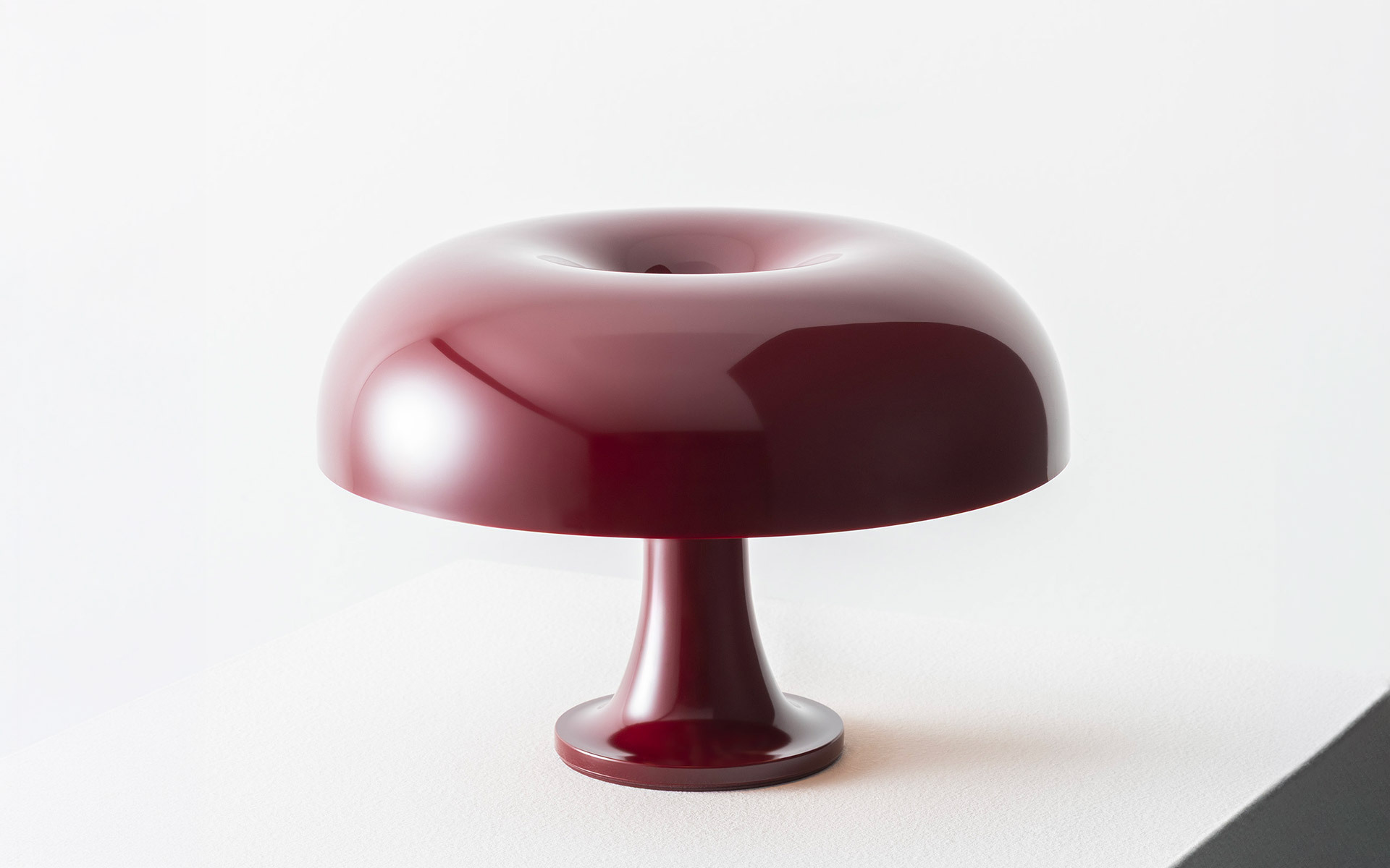 Bordeaux Nessino lamp on a white plinth.