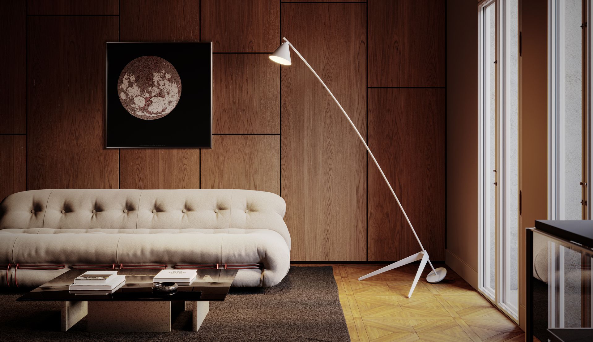 White arc floor lamp with conical shade on tripod base, beside a cream tufted sofa, against warm wood-paneled wall with moon artwork.