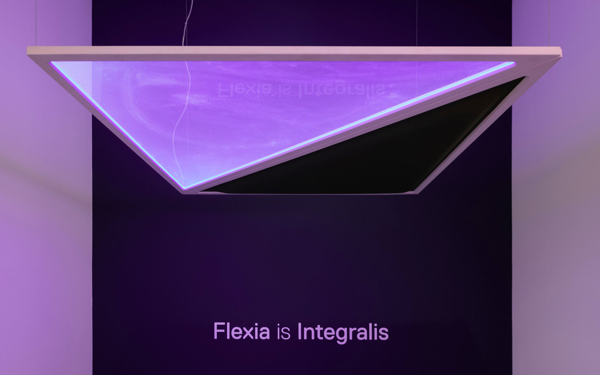 Artemide Flexia Integralis suspended lamp emitting purple light, with angular mirrored glass panel reflecting the brand name