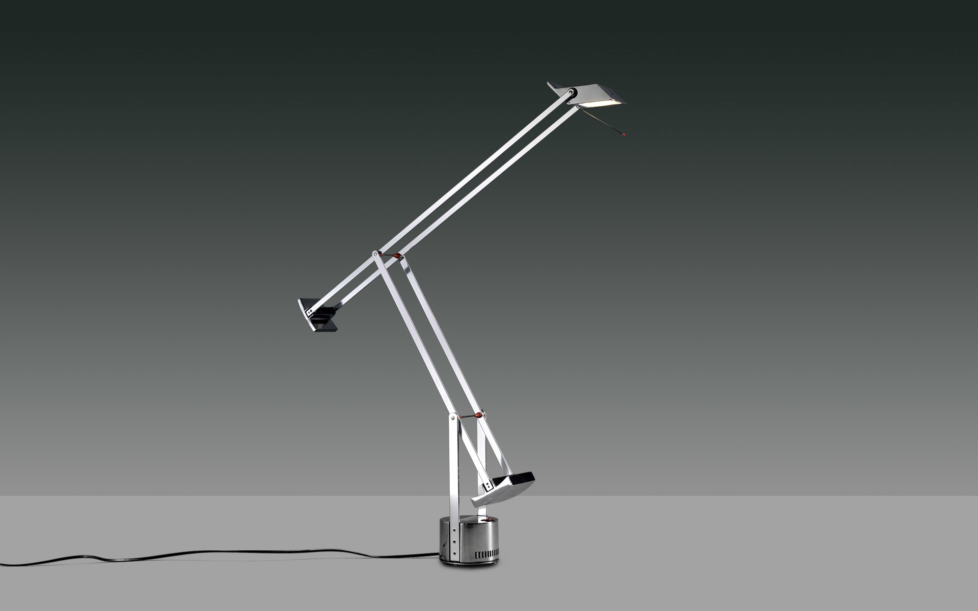 Artemide Tizio desk lamp in silver aluminum, featuring iconic counterbalanced articulated arm design on a weighted base