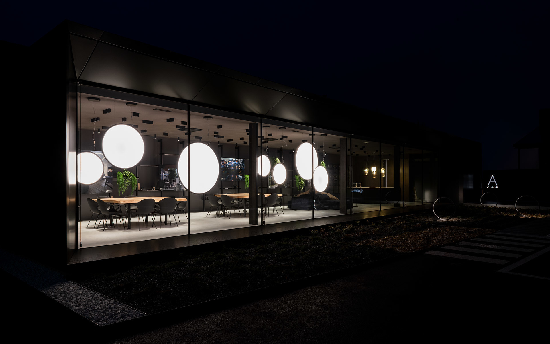 Modern glass pavilion at night showcasing large glowing spherical pendant lamps illuminating a dining area with chairs and plants.