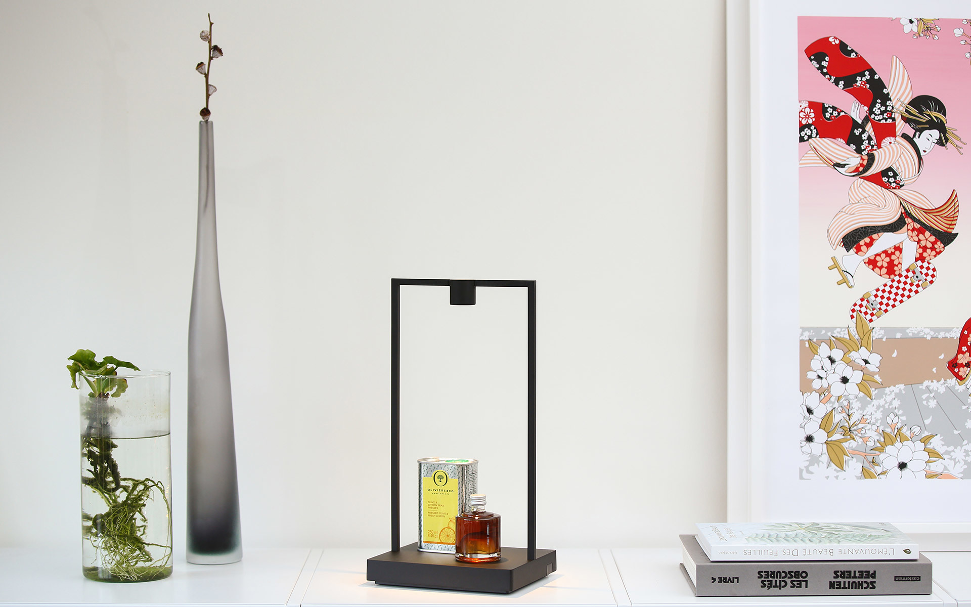 Black rectangular frame table lamp with LED strip, displayed on a white shelf beside a glass vase and decorative items