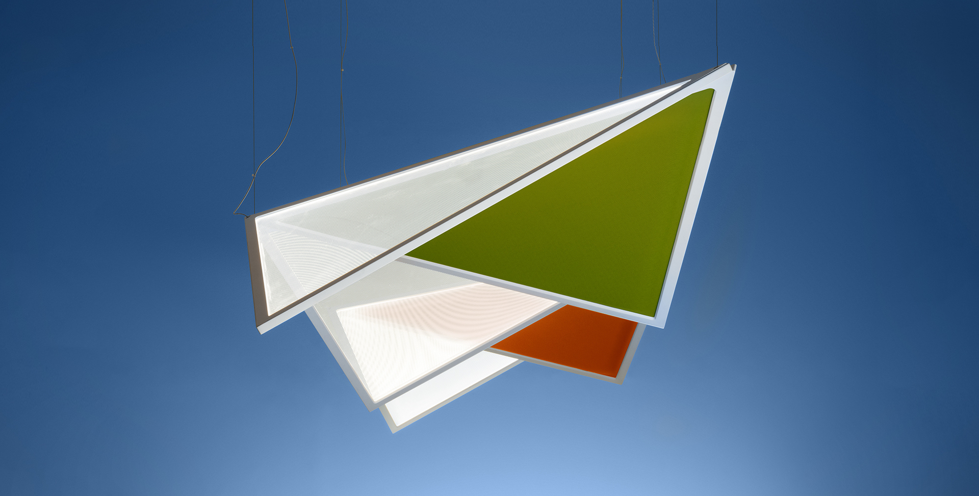 Artemide pendant lamp with overlapping triangular panels in white, olive green, and orange, suspended by thin cables against blue background