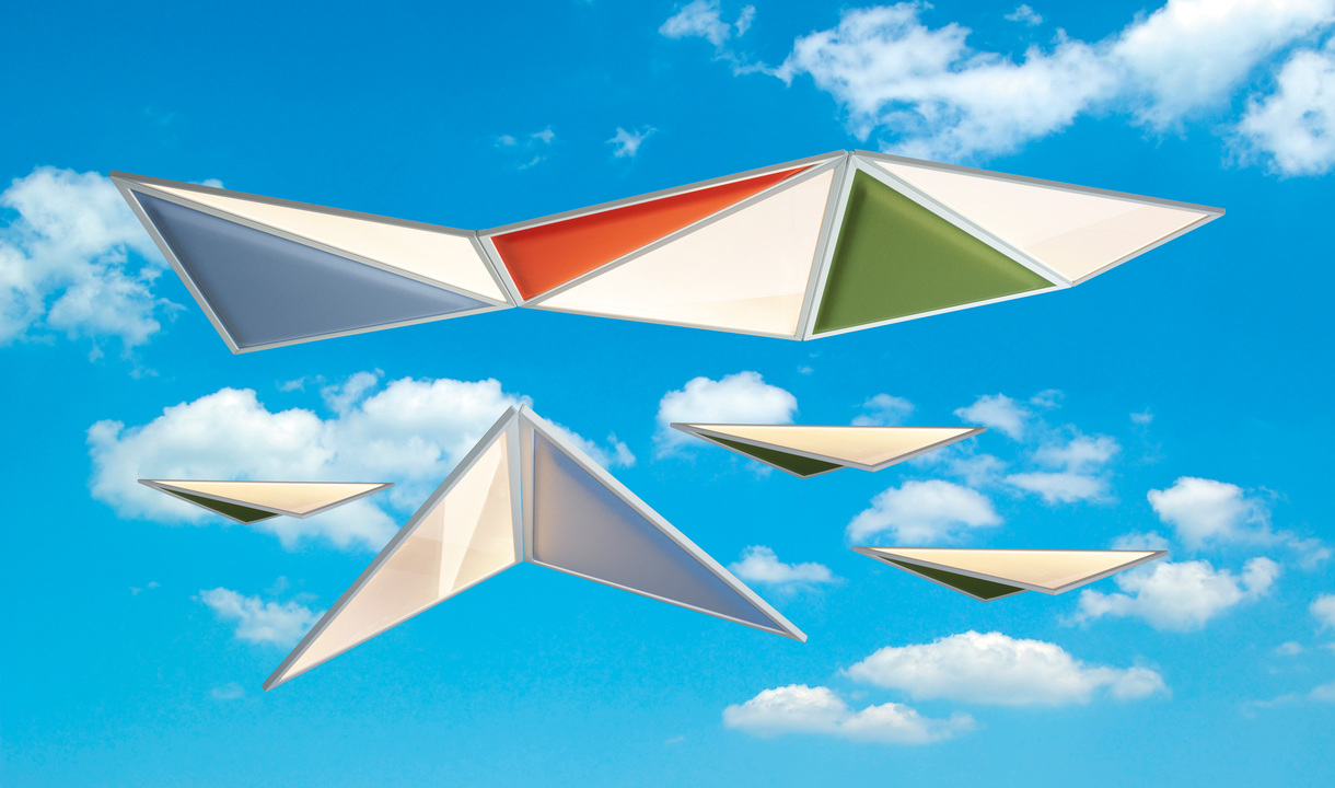 Artemide geometric triangular pendant lamps in white, red, green, and grey, arranged in a flying formation against a blue sky