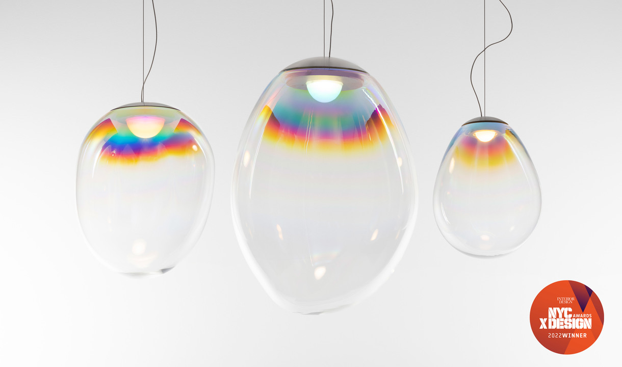 Three Artemide iridescent glass pendant lamps in egg shapes, displaying rainbow light reflections, NYC X Design 2022 Winner