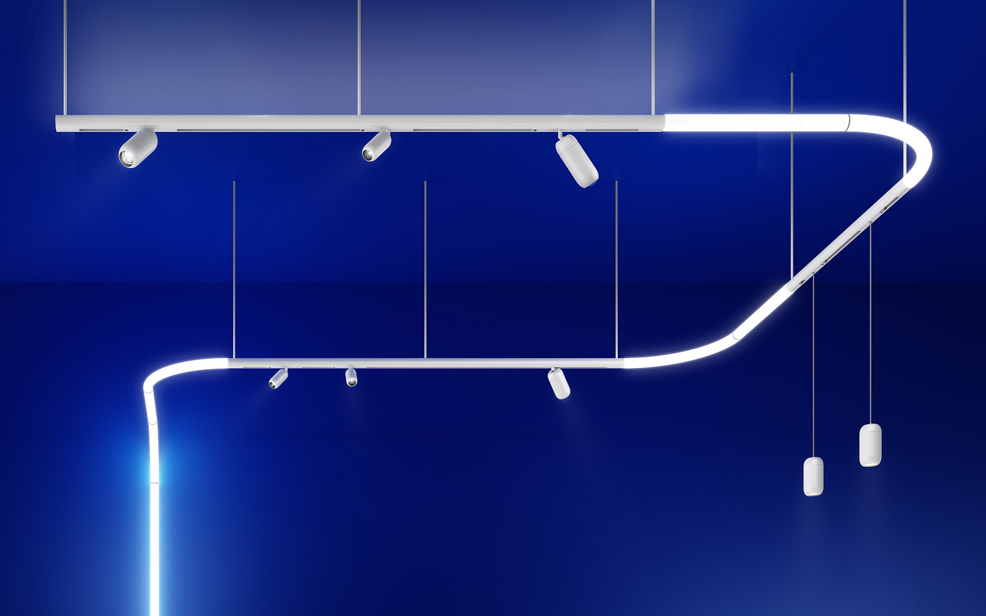 Artemide white modular lighting system: curved LED track with integrated spotlights and cylindrical pendants against deep blue background