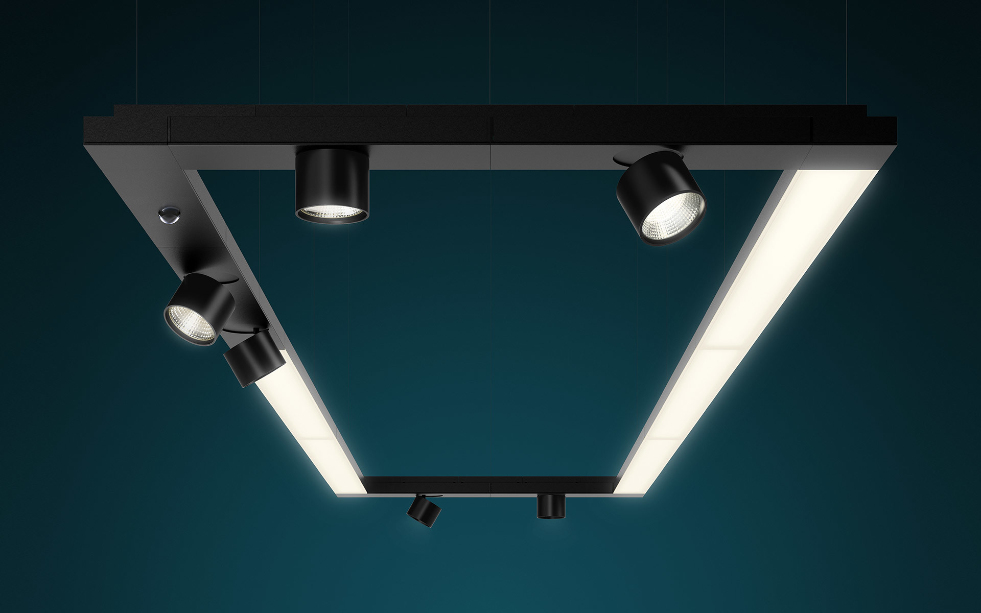 Black rectangular pendant light system with integrated LED panels and four adjustable cylindrical spotlights, suspended against teal background
