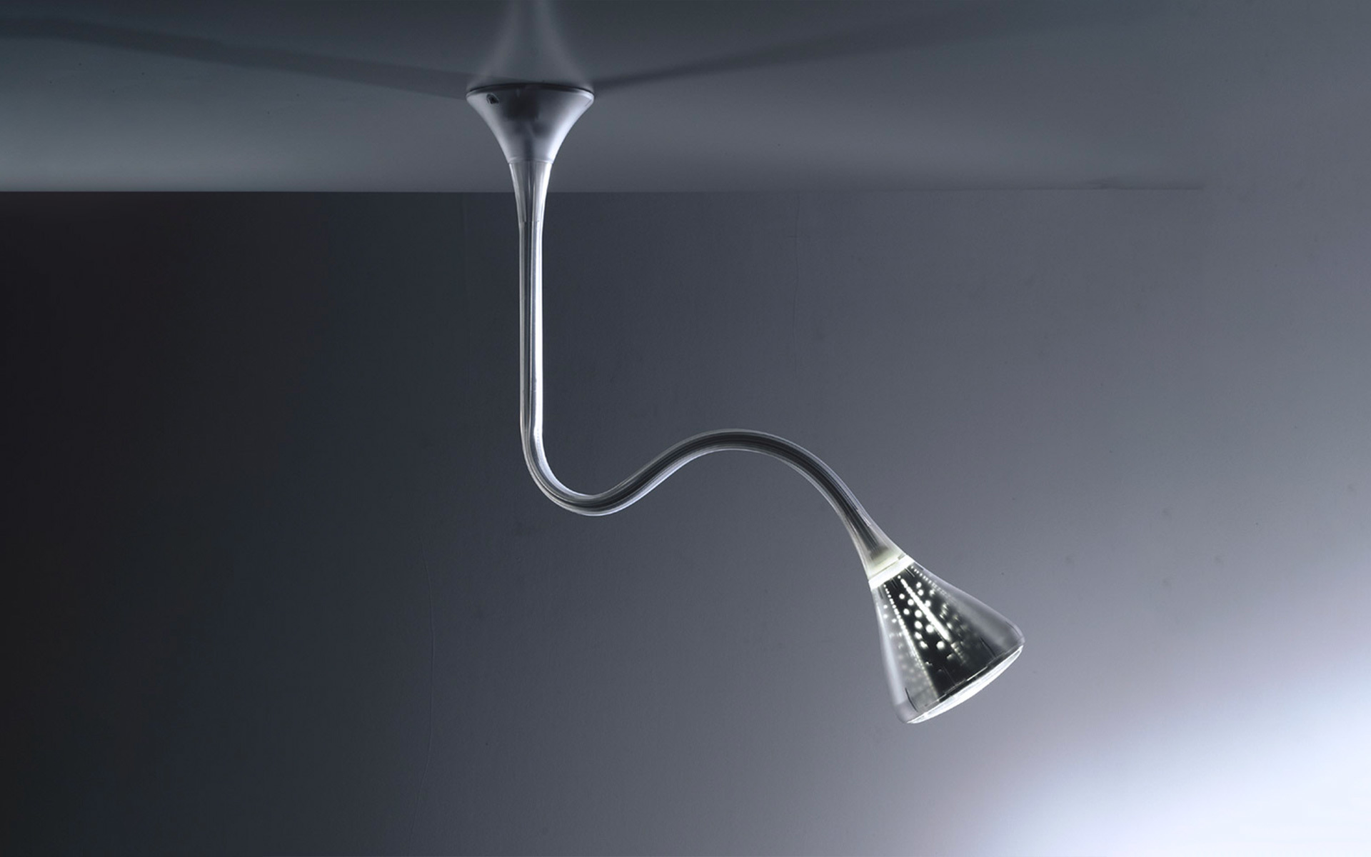 Artemide ceiling lamp with flexible chrome gooseneck arm, conical perforated metal shade with LED light, mounted on ceiling
