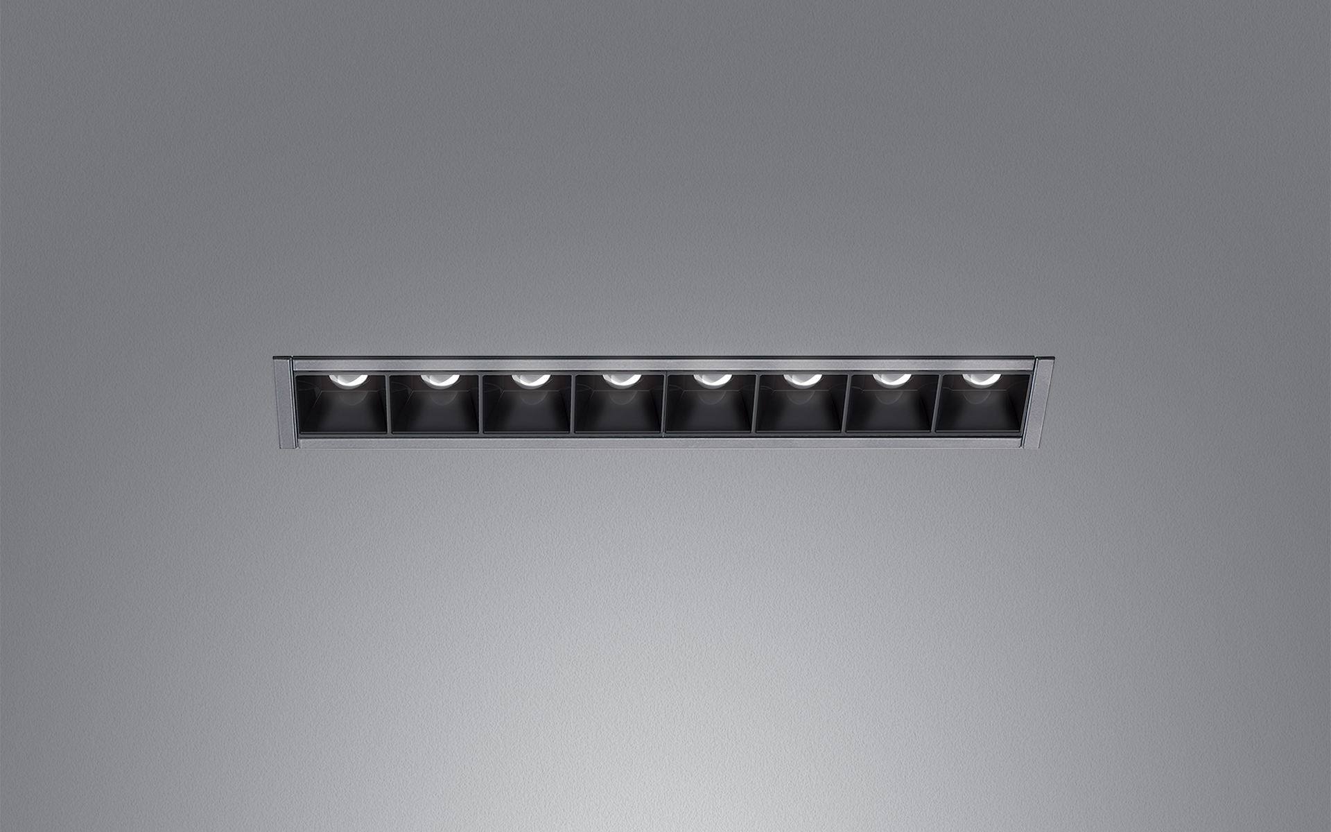 Artemide recessed linear LED fixture with eight black square cells in a slim aluminum trim, designed for ceiling installation