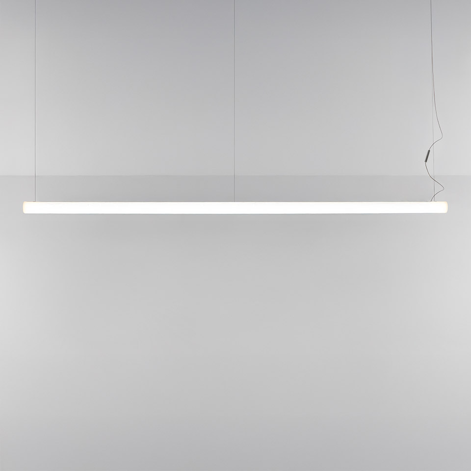 Artemide Alphabet of Light Linear pendant lamp: sleek white LED bar suspended by thin cables, emitting uniform diffused light