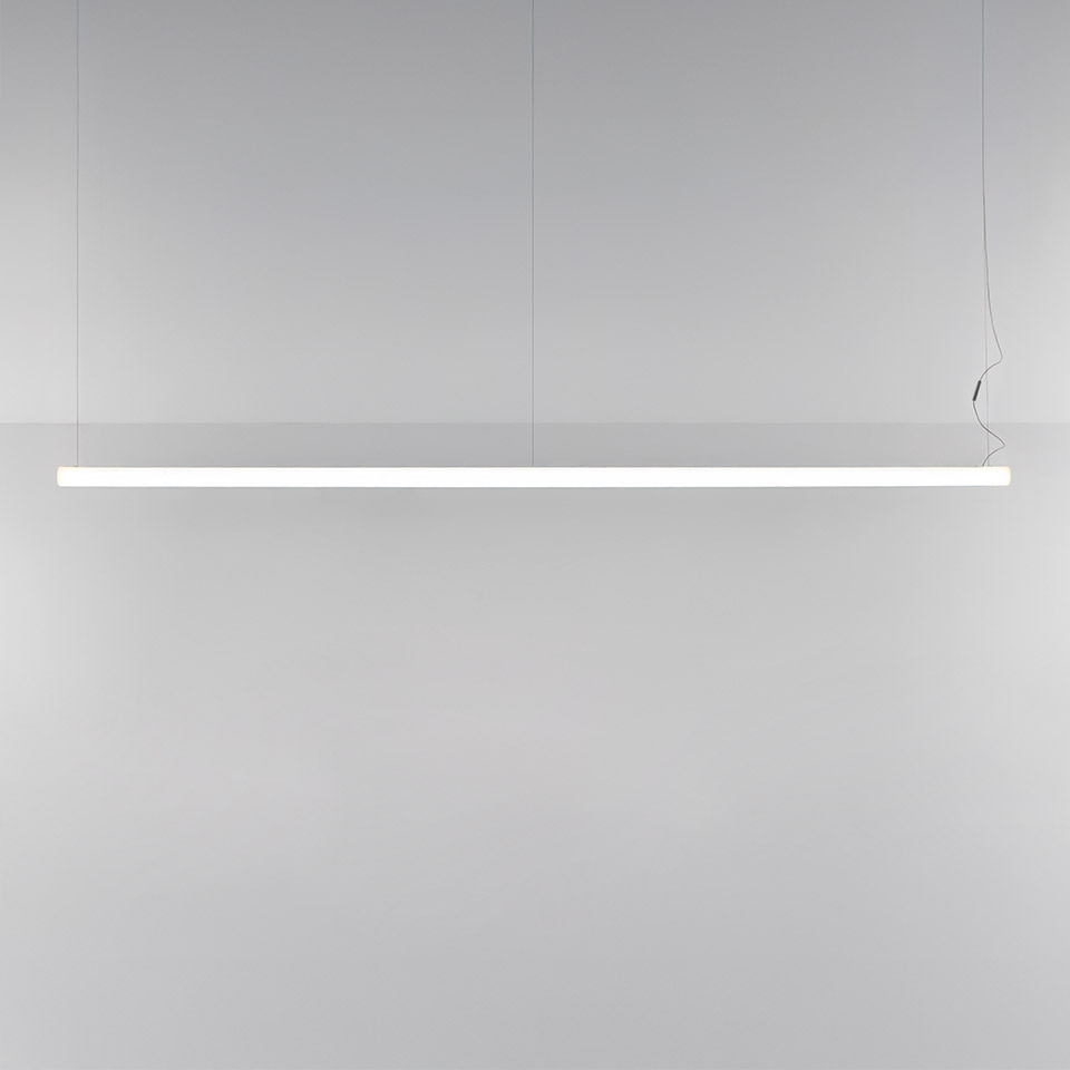 Artemide Alphabet of Light Linear pendant lamp: slim white horizontal LED bar suspended by thin cables, emitting uniform diffused light