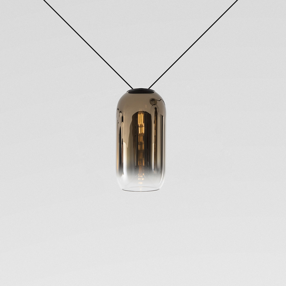 Artemide Funivia pendant lamp: cylindrical smoked glass diffuser with gold gradient, suspended on two diagonal black cables