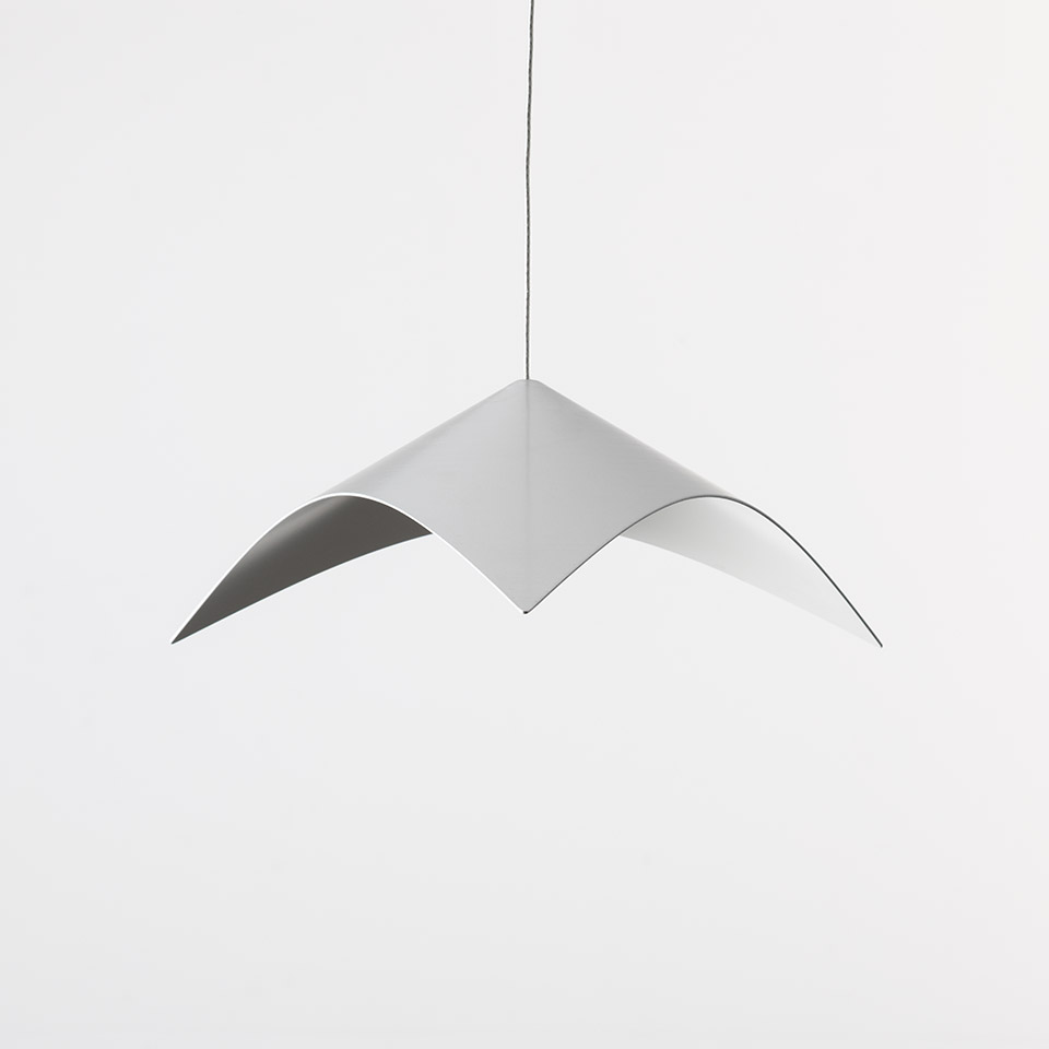 Artemide Iperbole pendant lamp with white curved wing-shaped shade suspended from a thin black cable