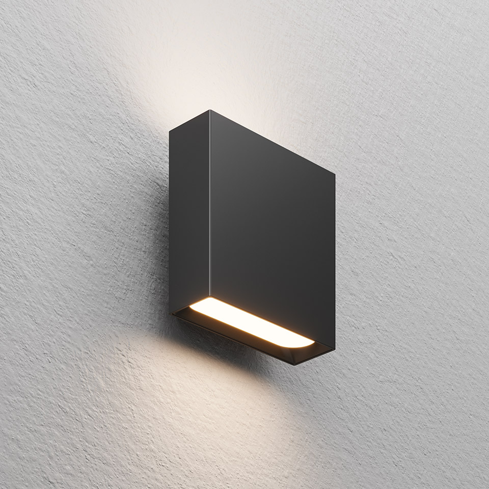 Artemide Agathe wall lamp in dark grey, rectangular body with horizontal LED strip emitting warm light upward and downward
