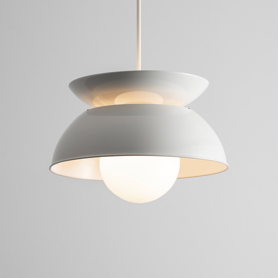 Artemide Cetra pendant lamp: two stacked white metal dome shades with a frosted glass globe bulb at the bottom, suspended by a white cord