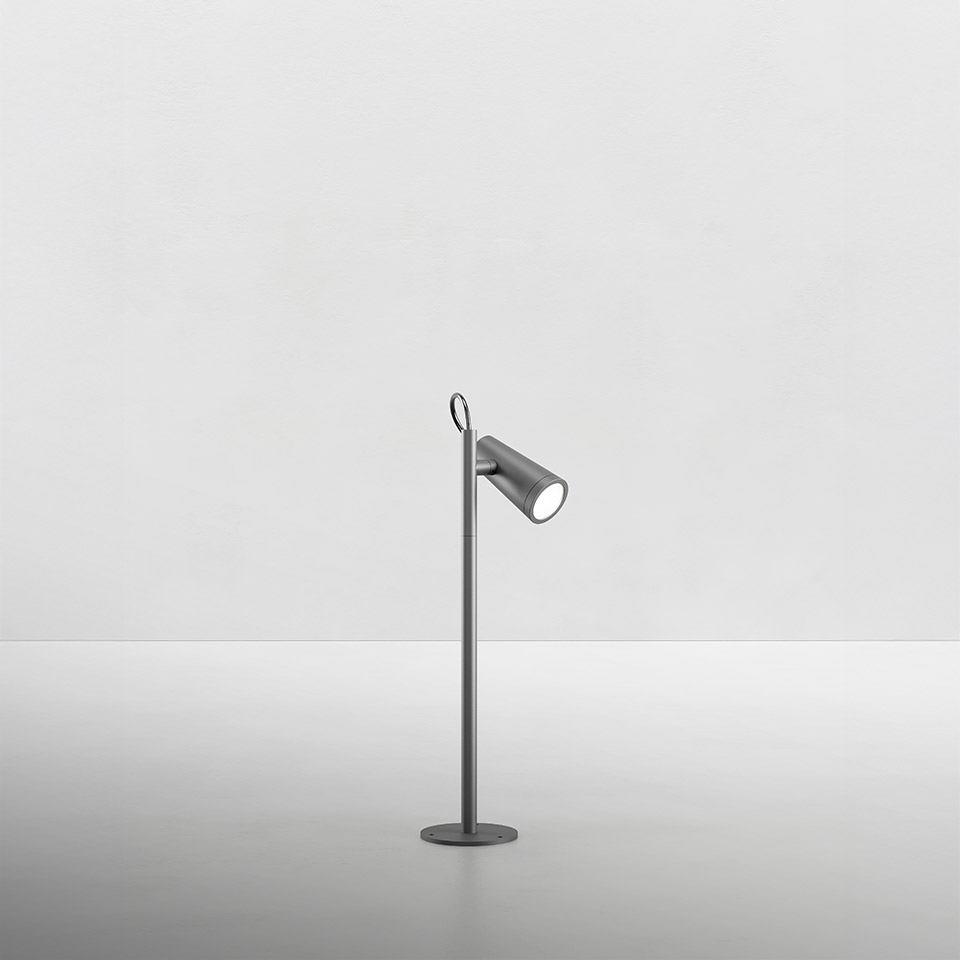 Artemide Conus floor lamp in grey, slim stem with round base, adjustable cylindrical LED spotlight head and top loop detail