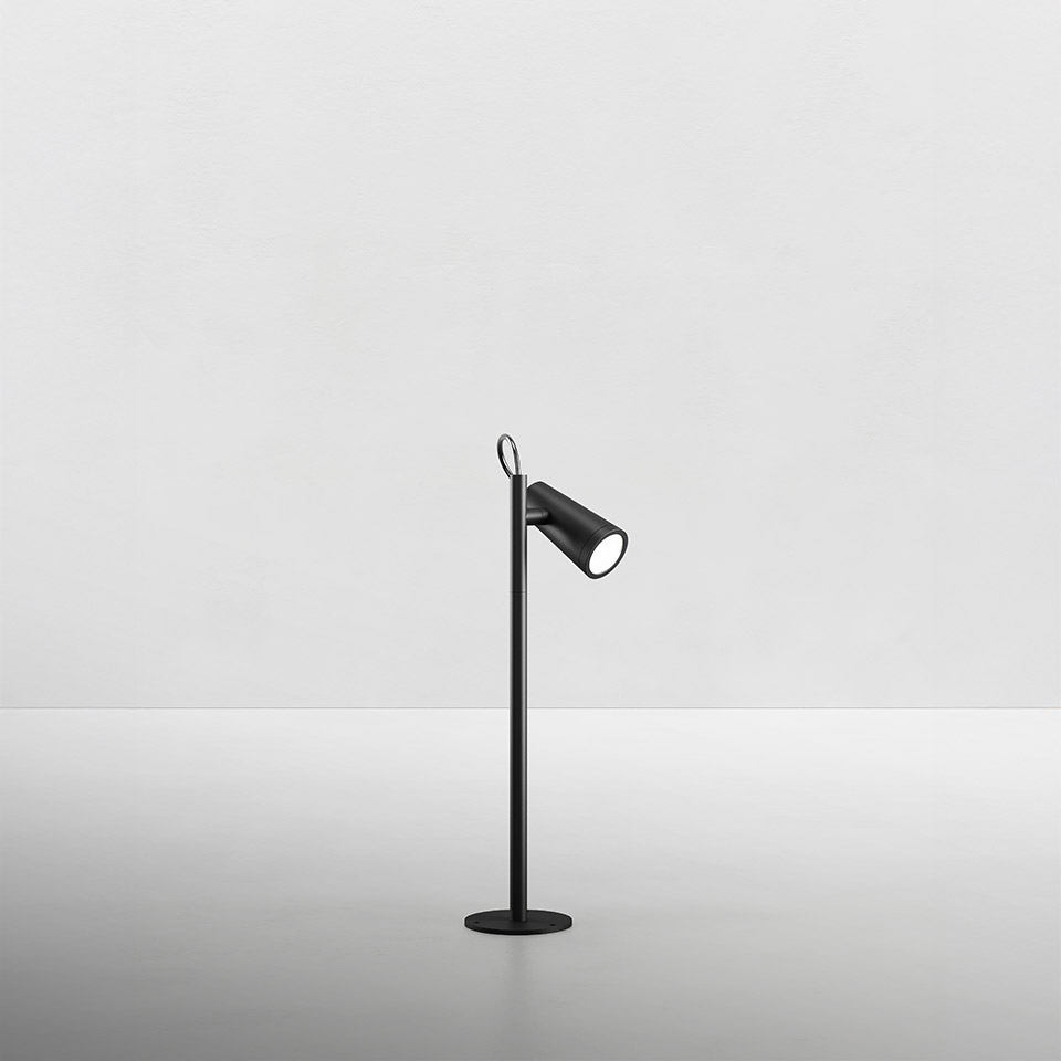 Artemide Conus table lamp in matte black, slim stem with ring detail, adjustable cylindrical spotlight head on round base