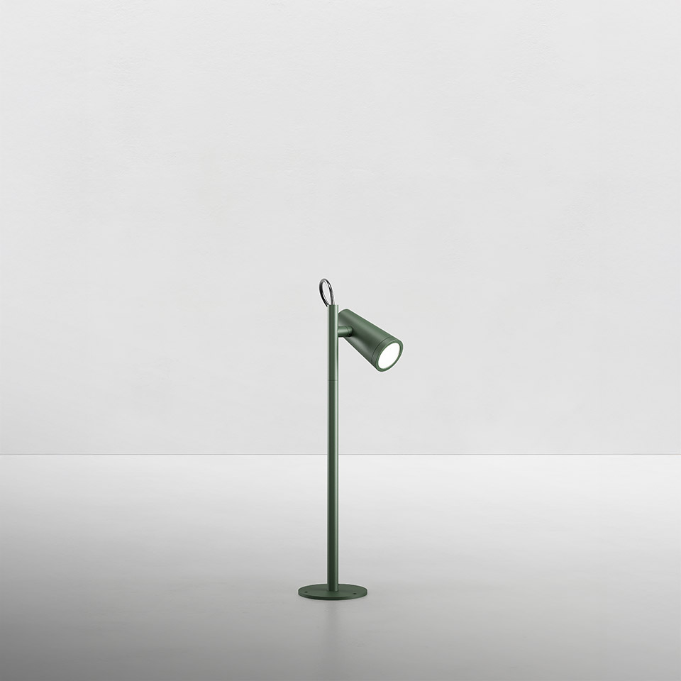 Artemide Conus table lamp in sage green, slim stem with circular base, adjustable cylindrical spotlight head and small top ring