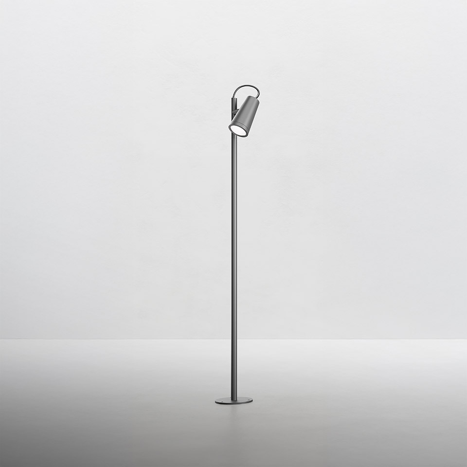 Artemide Conus floor lamp: slim metal pole with adjustable cylindrical spotlight head in grey finish, mounted on a round base