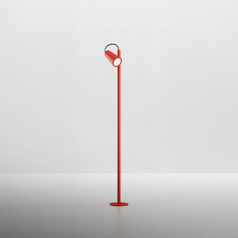 Artemide Conus floor lamp in red, featuring a slim pole with adjustable cylindrical spotlight head on a circular base