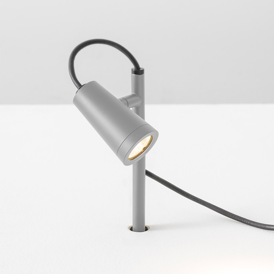Artemide Conus outdoor spike spotlight in grey, cylindrical LED head on angled stem with black cable