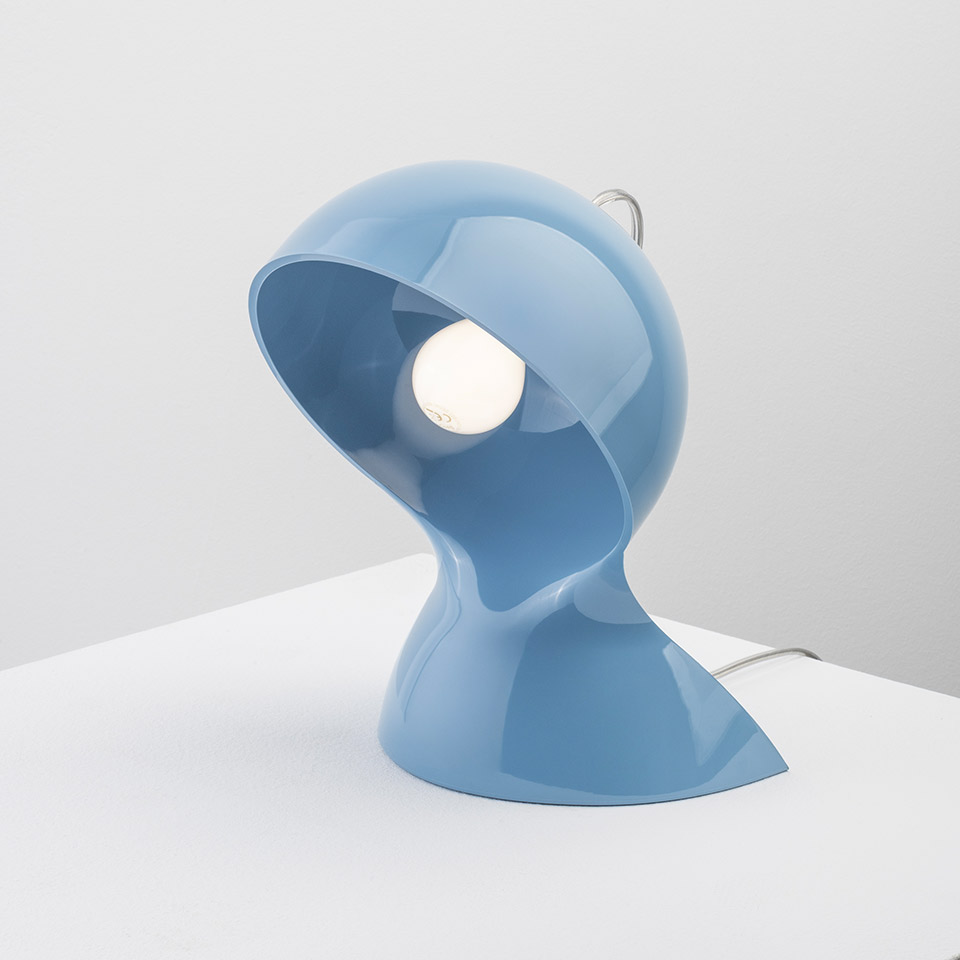 Artemide Dalù table lamp in glossy light blue, featuring a sculptural helmet-shaped shade with exposed bulb and rotatable head