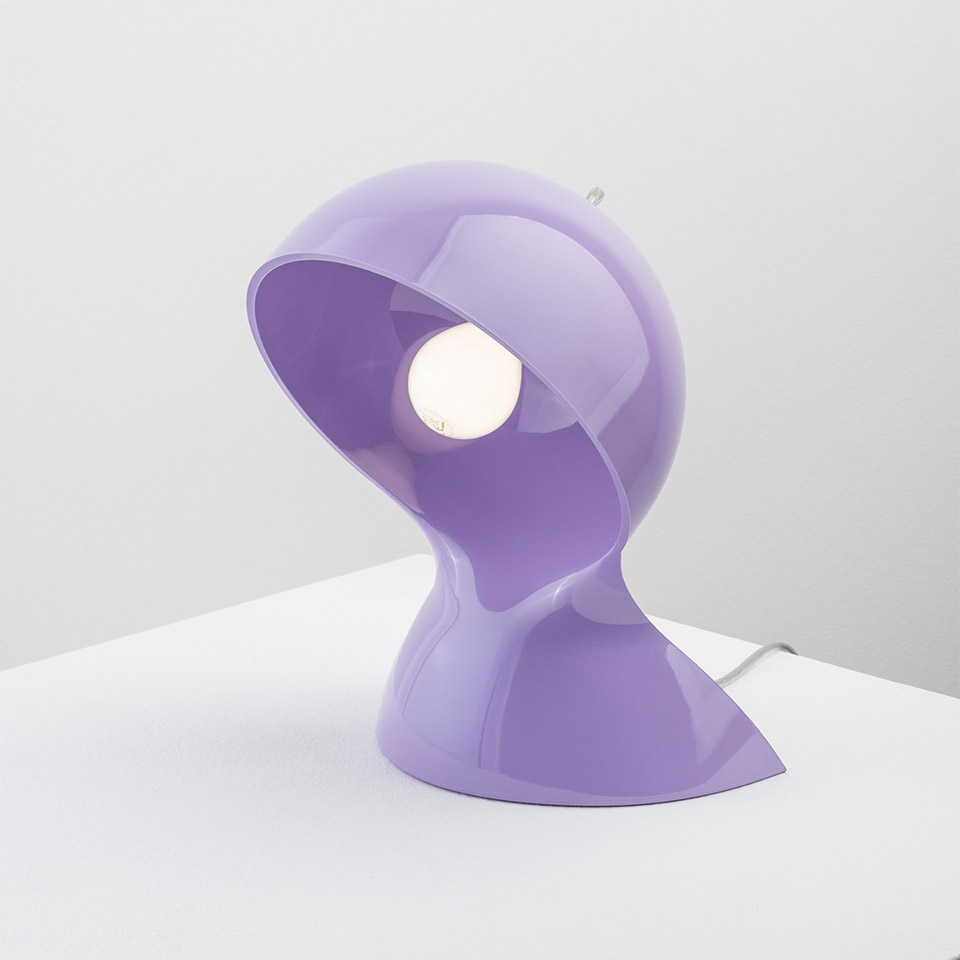 Artemide Dalù table lamp in glossy lilac, featuring a sculptural rounded shade tilted to reveal a globe bulb