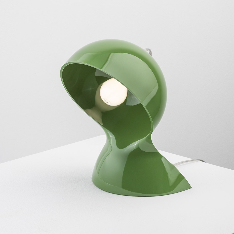 Artemide Dalù table lamp in glossy green, sculptural helmet-shaped shade with visible bulb, adjustable orientation