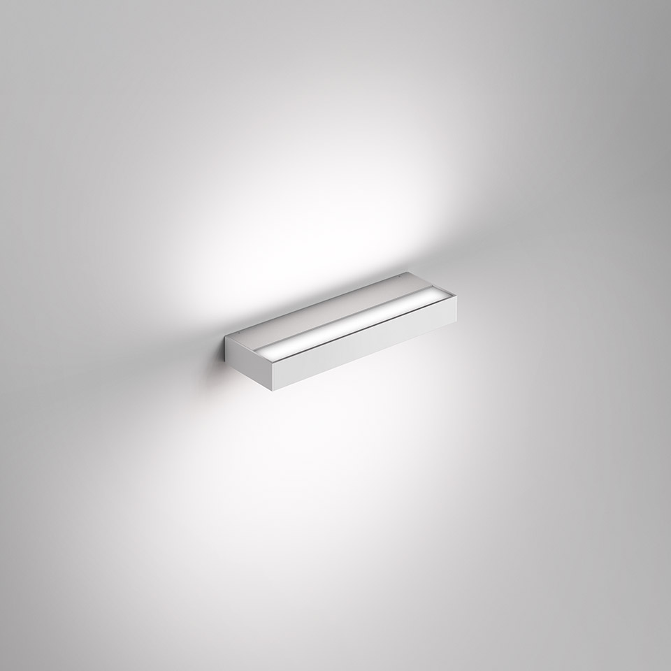 Artemide Hoy Parete wall lamp: slim rectangular white aluminum body emitting soft upward and downward light on wall