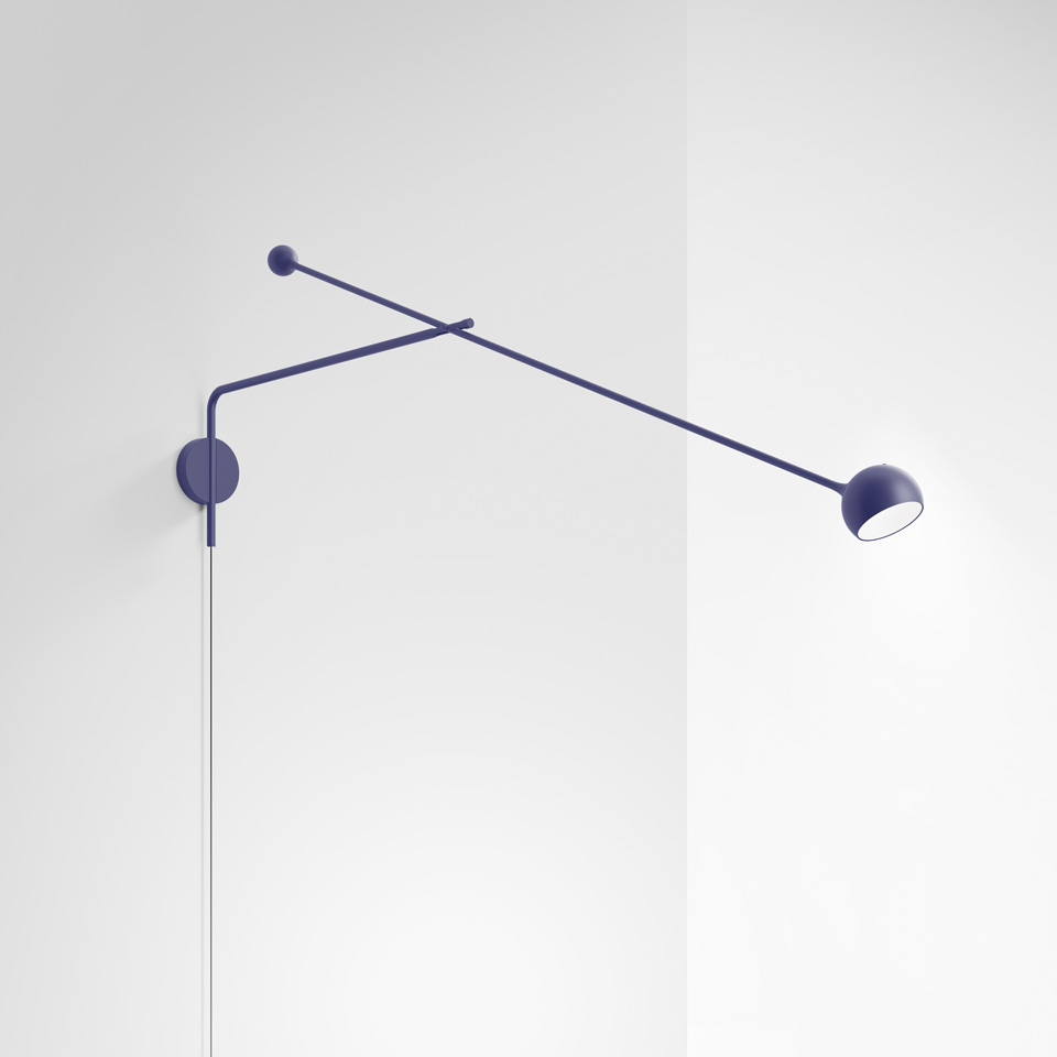 Artemide Ixa wall lamp in blue, featuring an adjustable two-arm structure with a small spherical head, mounted on a wall.